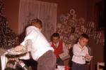 1960, 12: Doug, Wes, & Steve opening gifts