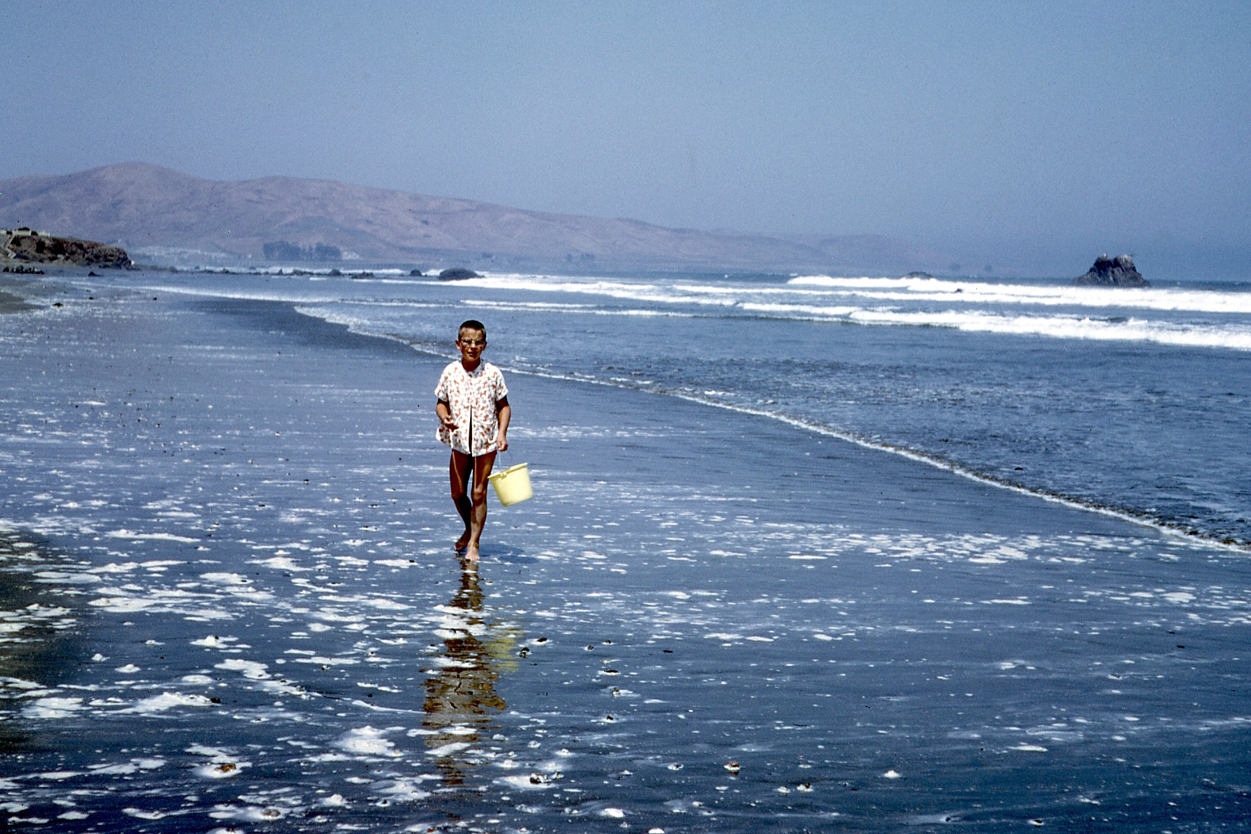 1965, 06: person on beach