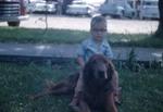 1958, 06:  Steve riding dog